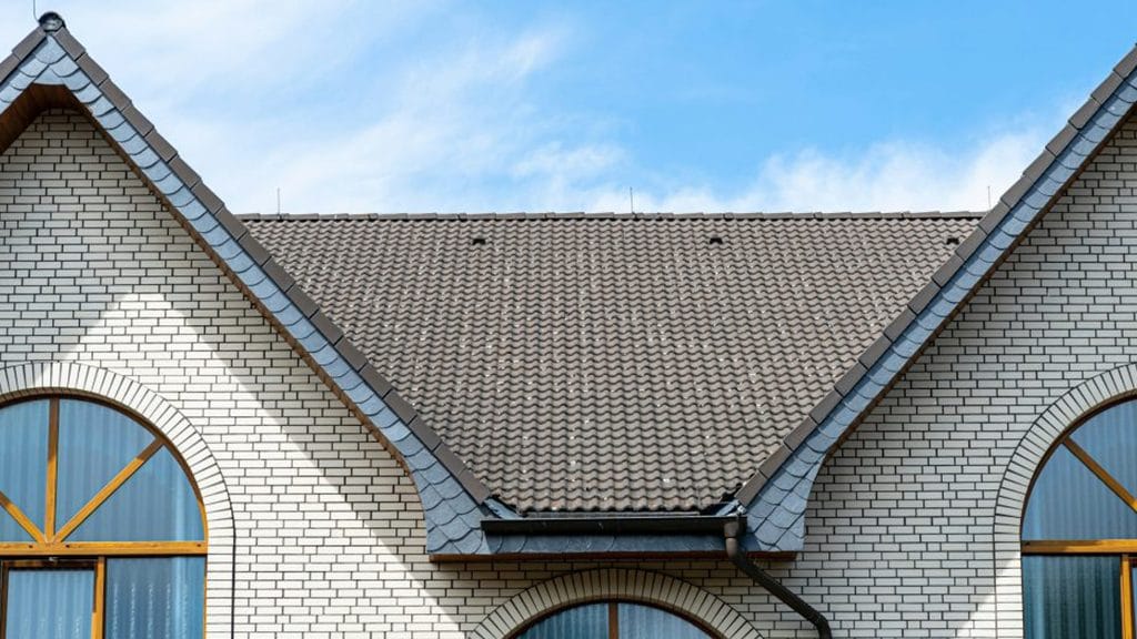 White brick and conical roof fascade by All Custom Roofing